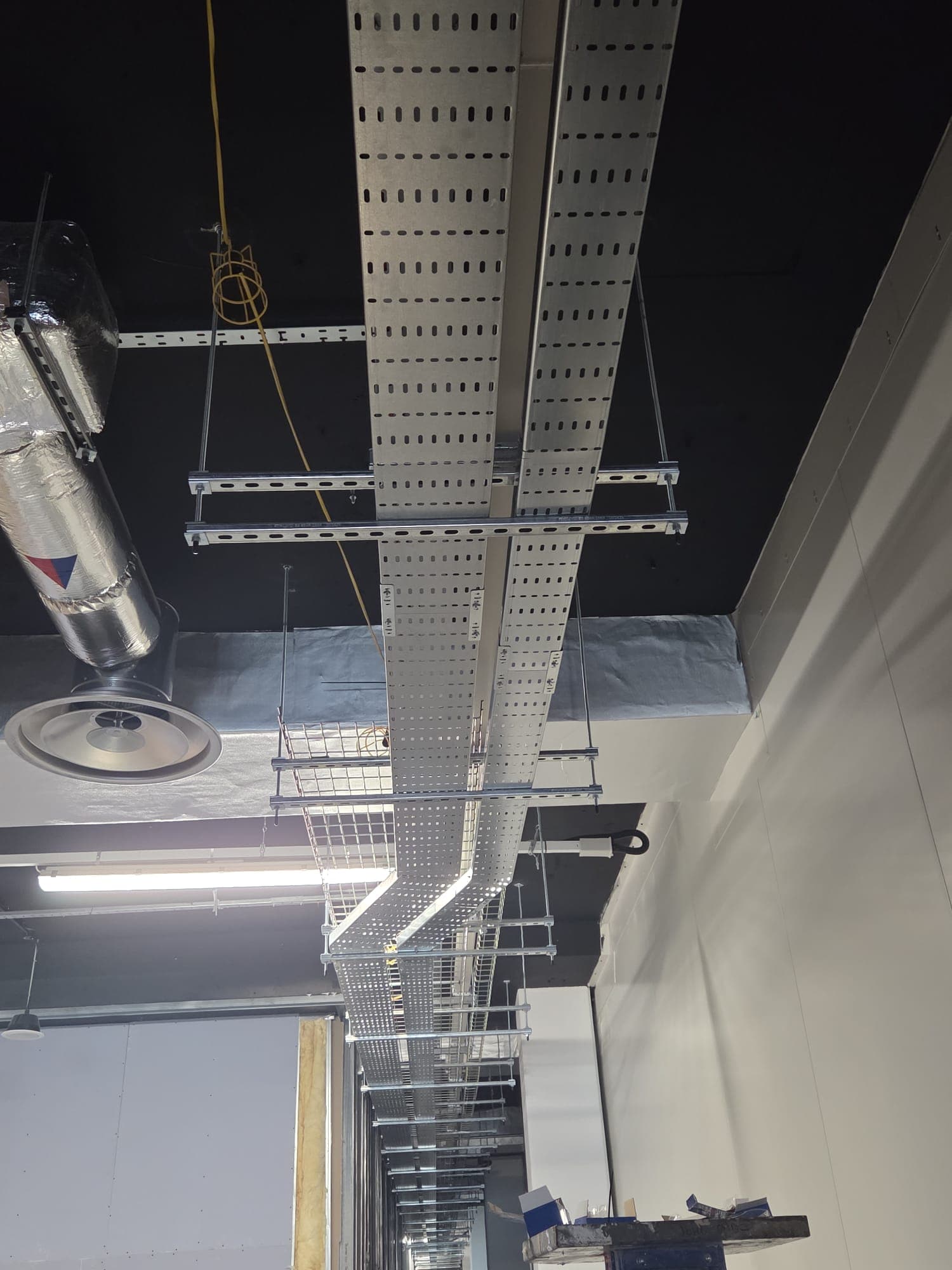 Overhead cable tray installation in a commercial ceiling